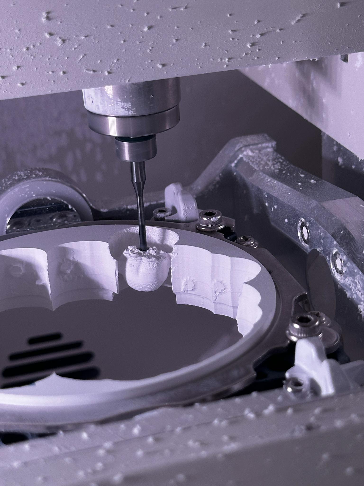 Close-up of a CNC milling machine creating detailed components.