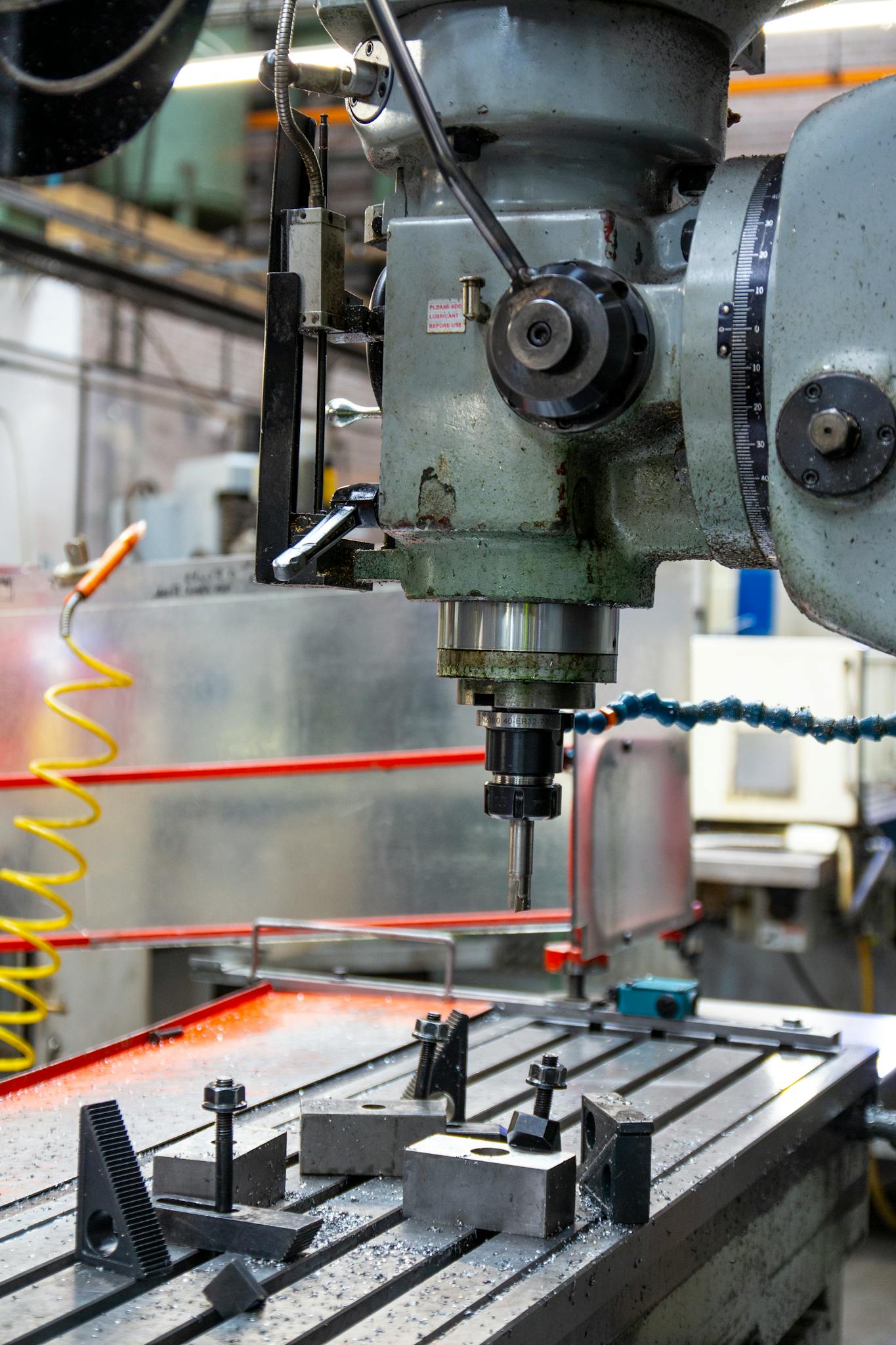 Close-up of a lathe machine in a workshop setting, showcasing precision engineering.